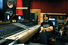 Eric Valentine, sitting in front of a recording-studio console