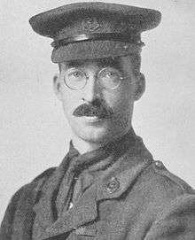 Bespectacled, mustachioed man in military uniform