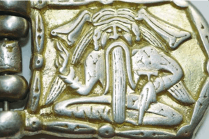 A buckle depicting a sitting man