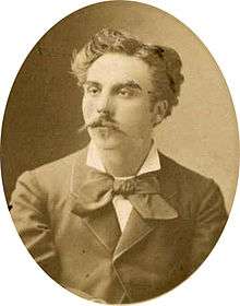 young man in semi profile, with luxuriant moustache and longish dark hair