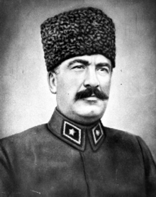 Older, soldier with a mustache wearing a fez