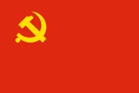 A golden, crossed, hammer and sickle placed on a red background.