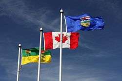 The flags of Saskatchewan and Alberta flanking the flag of Canada in Lloydminster