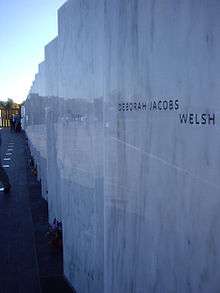 a marble wall with names inscribed on it.