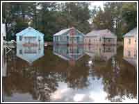 A flooded area, with houses in the background