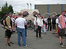 various people standing around a small Flying Spaghetti Monster Parade float.