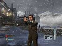 A man in a suit holding a gun. It is snowing, and a factory is on the background. On the bottom corners icons indicating ammo and health of the player can be seen.