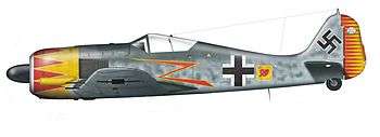 A fighter aircraft, shown in profile, viewed from the left. The aircraft is grey, with a yellow and red nose and a yellow and red rudder at the rear. Decorations include a stylized yellow and red lightning bolt, black-and-white crosses on the body and on the wing, and a black swastika on the tail.