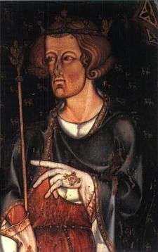 A pale, brown-haired man holding a sceptre and wearing a crown. He is clothed in a black and robe over a white shirt, and is wearing pale gloves