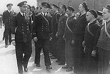 In this photograph, King George VI is inspecting the crew of the Norwegian ship HNoMS Draug, which was docked in Portsmouth sometime during the war.