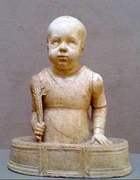 Sculpture of St. Quriaqos as a bald toddler standing in a small tub and holding a palm branch