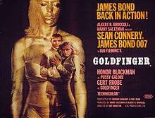 On a black background, a woman in underwear painted gold stands on the left. An image of Bond and a woman is projected on the right side of the woman's body. On the left is a phrase of the tagline: "James Bond Back in Action". Below is the title and credits.