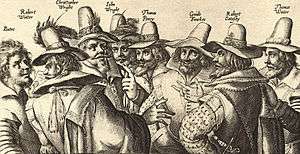 A monochrome engraving of eight men, in 17th-century dress.  All have beards, and appear to be engaged in discussion