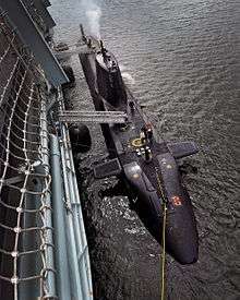 Photograph of Diligence alongside a submarine