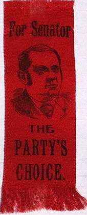 Campaign ribbon in red, rectangular and oriented vertically. At top, it bears the legend "For U.S. Senator" followed by an image of Hanna and the words, in large letters "The party's choice".