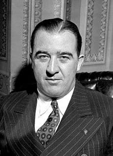 A black and white photo of a man in his forties wearing a suit