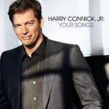 Harry Connick Jr. in a black jacket and black shirt, white background, black text