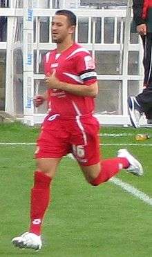 A man wearing a red football kit.