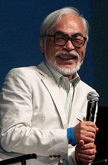 Picture of Miyazaki holding a microphone