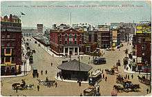 Colored print image of a city square in the 1900s