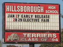Hillsborough High School letter board of upcoming events, with "Terriers Class of '94" and dog mascot logo.
