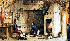 Two men in front of a fireplace about to exchange a drink