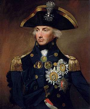 Portrait of a man in an ornate naval uniform festooned with medals and awards.