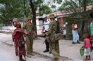 Photograph of Australian members of International Forces East Timor (INTERFET), talking to a citizen in Dili, East Timor in 2000