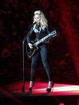Madonna playing a guitar
