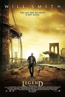 A man wearing leather clothes and holding a rifle walks alongside a dog on an empty street. A destroyed bridge is seen in the background. Atop the image is "Will Smith" and the tagline "The last man on Earth is not alone". Below are the film's title and credits.