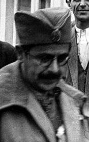a male with a moustache and glasses wearing military uniform