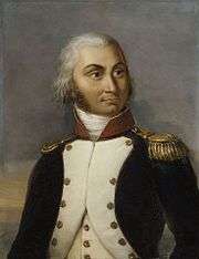 Formal half portrait of Jourdan in dress military uniform, wearing a dark coat with white lapels, a red shoulder sash and gold waist sash. He has golden epaulets on his shoulders. He is an older man with gray hair pulled into a pony-tail, a fair face and a long nose.