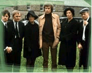 Six adults outdoors, in funeral clothing