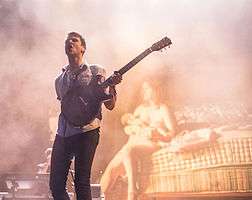 Jamie T playing guitar in concert