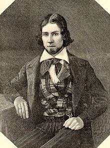 Engraving of a young man with hair parted in the middle, wearing a plaid vest  and suit coat. He is looking at the viewer.