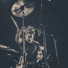 Jamie Stewart playing drums
