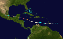 A map showing the path of a hurricane, with colored dots representing the storm's position at six-hour intervals, as well as its intensity based on a color scheme. The path begins at the right, moves generally to the left and crosses two land masses during that trek.