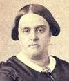 Sepia photograph showing the head and shoulders of a middle-aged woman wearing a dark dress with thin white collar