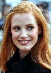 Jessica Chastain smiles while she gently looks away from the camera