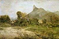 A landscape painting depicting houses nestled among trees in the middle-distance, and a large hill topped by a rock spire in the far distance