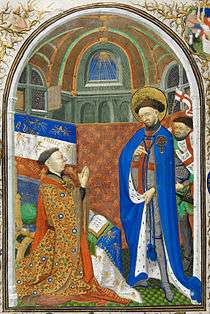A 15th century man prays in front of a Christian saint