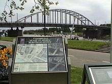Colour picture of memorial with the bridge in the background