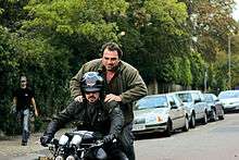 Director Jon Ivay, rides on a motorcycle on the set of Freebird.
