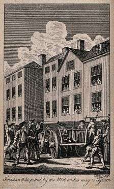 Jonathan Wild, the thief-taker, sitting on a cart, is pelted by the mob on his way to Tyburn.