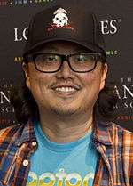  A picture of an Asian man who wears glasses and smilles.