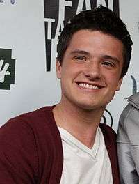 Josh Hutcherson smiling for a picture wearing casual clothing