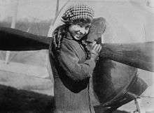 Lady standing jauntily in front of an aircraft