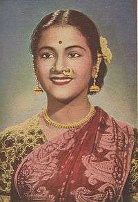 Young smiling Indian woman wearing a sari.