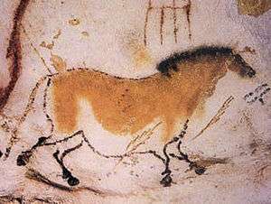 Outline drawing of a horse on a cave wall with yellowish paint on the body and a black mane