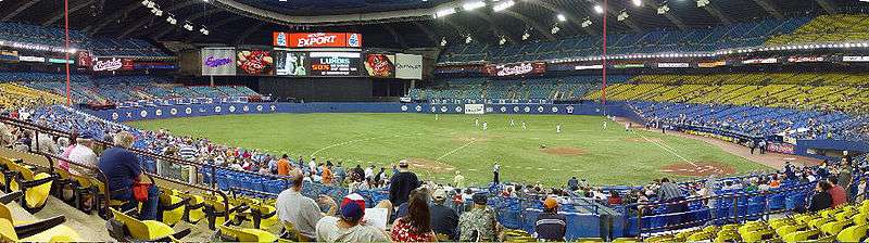 A sparse crowd watches as the Expos take to the field.
